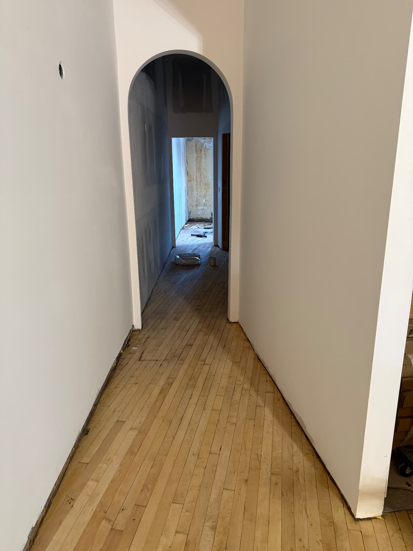 The same hallway with the walls painted and the floor sanded clean and smooth