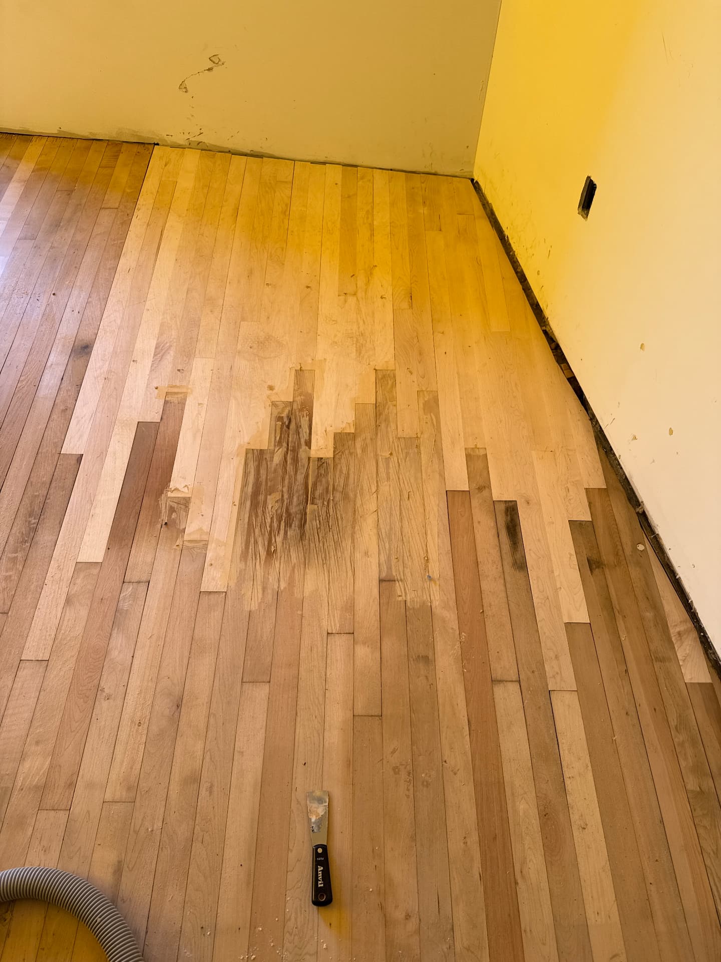 New boards laced into the existing floor with the seam filled before sanding